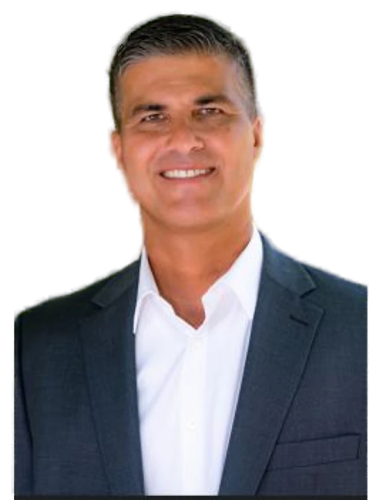 Val Martin, REALTOR with Keller Williams Realty Maui, smiling in a dark suit